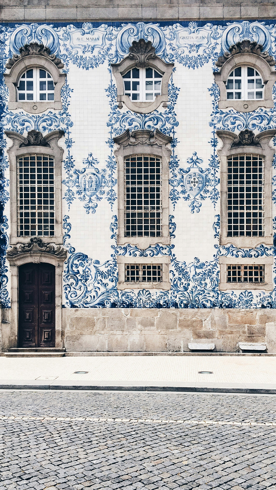 Historic Portuguese facade covered in ornate blue and white azulejo tiles