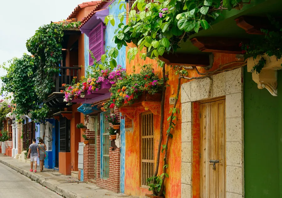 Colorful colonial buildings and flower-filled balconies along a street in Cartagena, Colombia